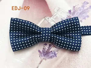 Detailed view of the blue and white polka dot children bow tie, polyester material.