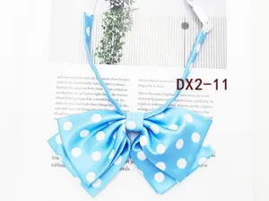 Detailed close-up of a blue and white polka dot JK uniform bow tie, cute daily style.