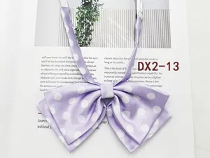 Detail view of light purple polka dot JK uniform bow tie with adjustable strap.