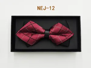 Detailed close-up of a burgundy plaid bow tie with black contrast layer in a gift box.