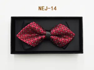 Detailed close-up of a red and black patterned bow tie neatly packed inside an elegant black gift box.