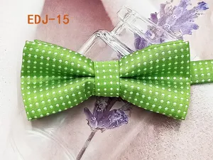 Green polka dot bow tie detail close-up, premium woven polyester children pet accessory.