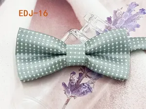 Detailed view of green polka dot children bow tie, elegant fabric texture and cute accessory.