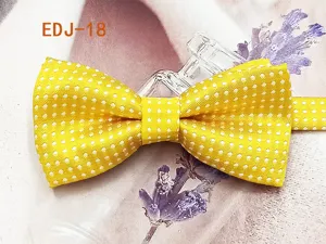 Yellow polka dot bow tie detail shot, showing cute double layer fabric and bright color texture.