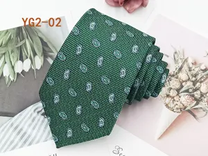 Detailed view of the green paisley jacquard necktie, featuring classic pattern and texture.