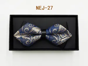 Closeup of a blue paisley patterned bow tie in a black gift box, elegant design detail.
