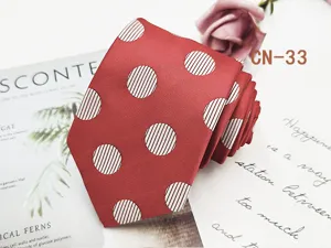 Detail shot of red men's business tie featuring white striped polka dots and fine jacquard texture.