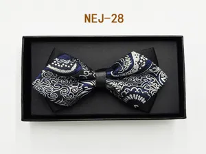Detailed shot of a blue and silver patterned bow tie in a black gift box, elegant fabric.