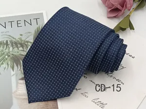 Detail view of men's navy blue jacquard tie with white micro polka dot pattern.