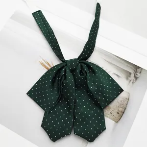 Dark green polka dot JK bow tie for women, sweet Japanese college style neckwear accessory.