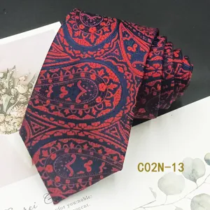 Detail shot of men red and navy blue jacquard tie with classic paisley pattern design.