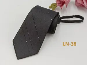 Close-up detail of dark brown woven zipper tie with elegant diagonal dotted stripe pattern.