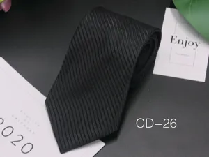 Black textured striped jacquard business tie fabric detail close up for formal wear.