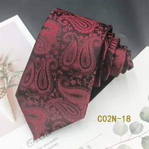 Detailed view of dark red silk-like paisley jacquard tie with classic pattern design.