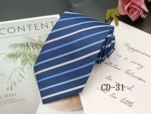 Blue striped men's business tie close-up, classic jacquard design for formal wear and office suit.