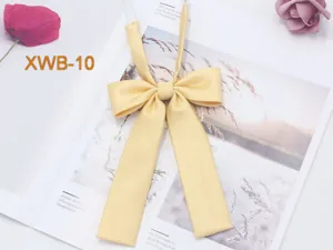Solid color twill JK uniform bow tie detail shot, elegant yellow long ribbon collar flower.