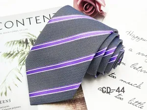 Men's business striped tie detail, classic purple and white diagonal stripes on dark fabric.