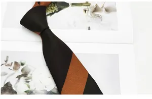 Close-up detail of vintage striped men tie, classic brown and black diagonal pattern fabric.