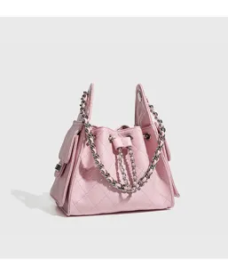 Detailed view of the pink quilted chain bucket bag with elegant metallic shoulder strap.
