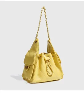 Yellow quilted chain bucket bag for women, stylish underarm commuter shoulder bag.