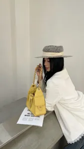 Detailed view of fashionable quilted chain bucket shoulder bag showcasing elegant women daily style.