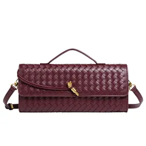 Burgundy woven leather top handle crossbody bag with metallic knot detail for women.