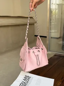 Detailed view of the stylish pink quilted leather bucket shoulder bag with chic chain straps.