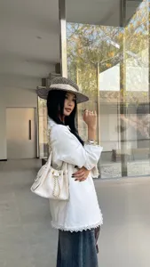 Women white quilted chain shoulder bag, stylish bucket underarm commuting handbag for daily use.