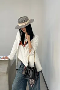 Black quilted chain bucket bag for women, elegant shoulder bag with premium leather style.