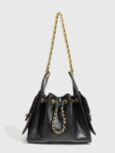 Classic black quilted leather bucket shoulder bag with elegant gold chain strap for women.