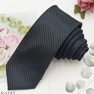 Detailed shot of black textured narrow necktie close up texture professional style