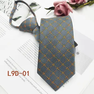 Vista di dettaglio della cravata grigia da uomo con elegante motivo jacquard geometrico giallo.