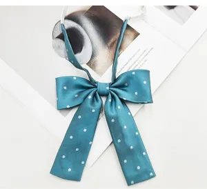 Detailed close-up of the blue polka dot JK bow tie showcasing the fine fabric texture clearly.