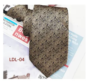 Detail view of the brown jacquard zipper tie featuring delicate subtle pattern texture.