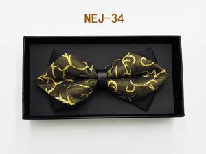 Men's black and gold patterned bow tie in a gift box, elegant wedding suit accessory.