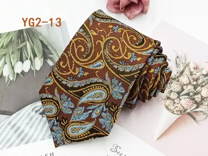 Close-up detail of the elegant brown paisley jacquard men's necktie, showing fabric texture.