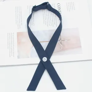 Dark blue cross tie detail, classic JK uniform collar bow with decorative button, fabric strap.