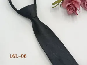 Black zipper necktie detail view, narrow pre-tied business tie featuring subtle textured pattern.