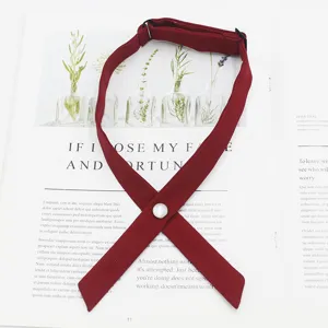 Solid color cross tie jk uniform collar accessory with button and adjustable strap for women.