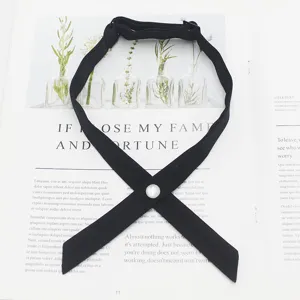 Detailed view of the black cross JK uniform necktie with elegant pearl button and strap.