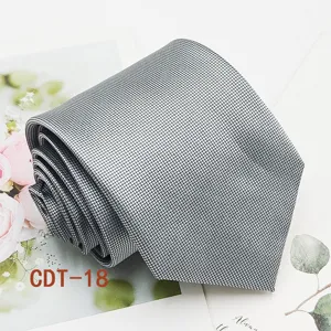 Detailed view of grey checkered men business necktie, classic textured jacquard fabric.