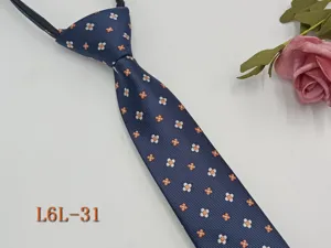 Slim zipper necktie for men with blue fabric and orange white floral pattern, detail view.