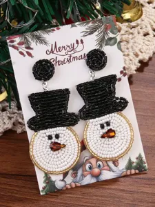 Detailed close-up of handmade seed bead Christmas snowman earrings on festive card.