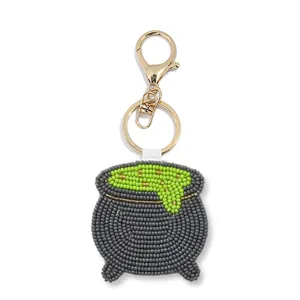 Handmade Halloween cauldron seed bead keychain with green potion design and gold hardware.