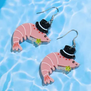 Close-up view of cute pink shrimp acrylic earrings featuring a black top hat and sparkling star.