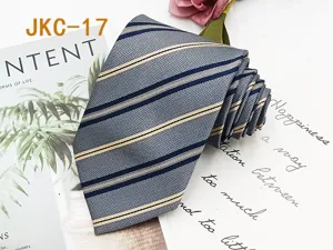 Close-up detail of the classic striped JK uniform necktie, featuring fine jacquard texture.