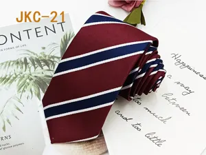 Classic striped necktie detail shot, showing burgundy fabric and blue white diagonal pattern.