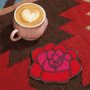 Handmade beaded rose coaster detail shot, elegant red and pink floral design for table decor.