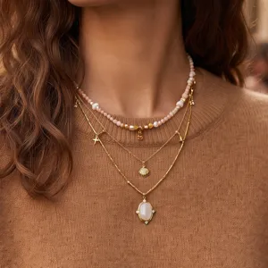 Layered vintage necklace set with white stone pendant and dainty gold chains for women.
