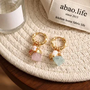 Detail shot of original design natural rough crystal hoop earrings with elegant gold finish.